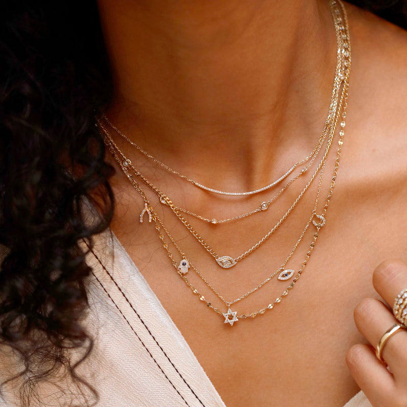 multiple sarah elise stacking necklaces with evil eye hamsa hand protective charms