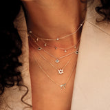 multiple sarah elise stacking necklaces with various charm pendants in solid gold for her