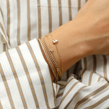 solid gold Cuban chain bracelet adorned with sparkling diamonds.