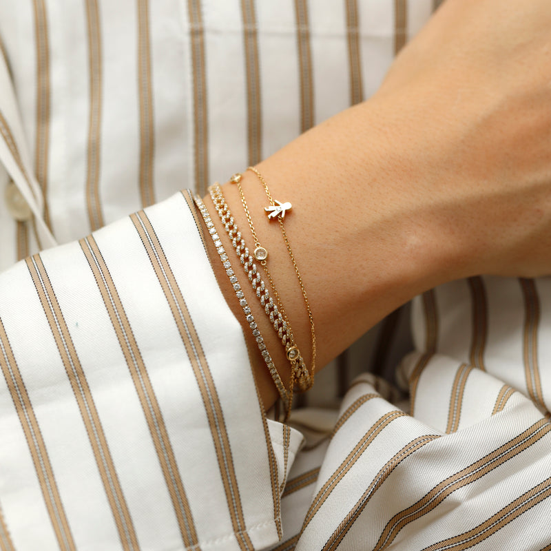 solid gold Cuban chain bracelet adorned with sparkling diamonds.