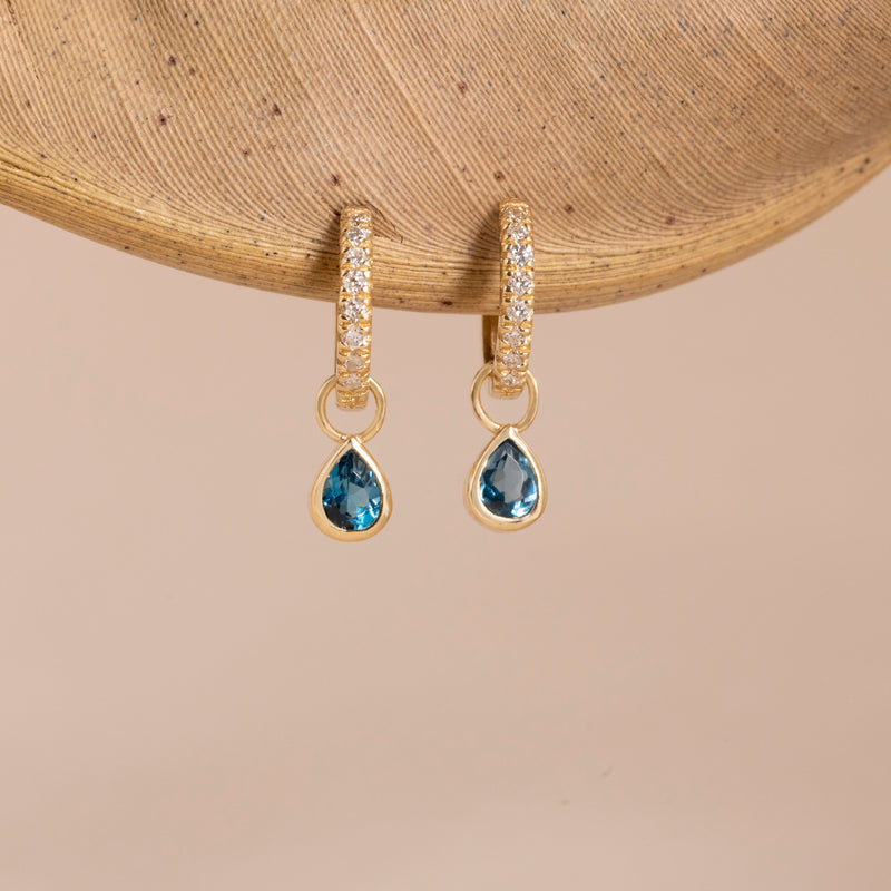 Pear cut blue topaz gemstone white diamond huggies