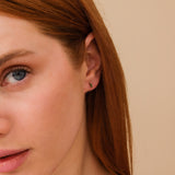 Model wears simplistic yet elegant green marquise emerald cut stone with single diamond gift for her. 