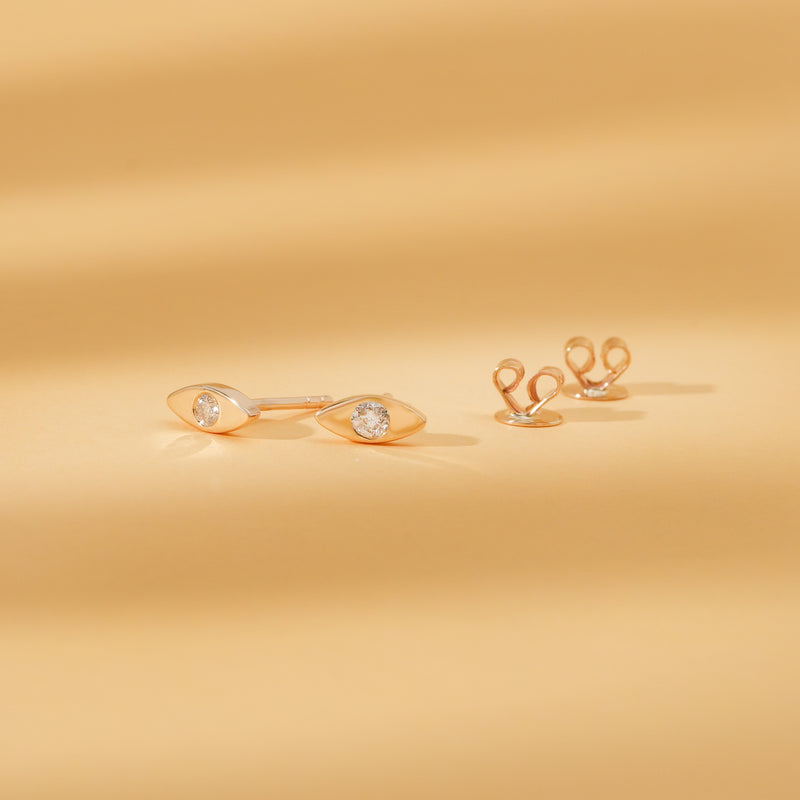 Pair of solid 14k gold with single diamond stud in eye shape