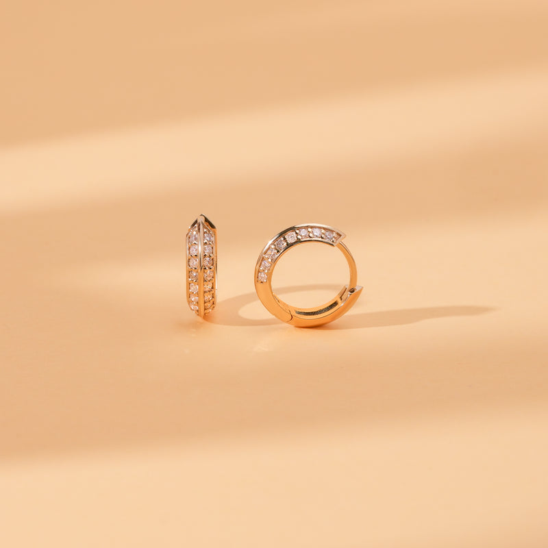side view of double edged diamond lined hoop huggie in solid 14k gold