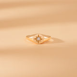 solid gold signet ring with clear diamond starburst
