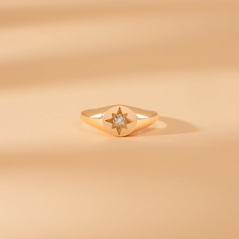 solid gold signet ring with clear diamond starburst