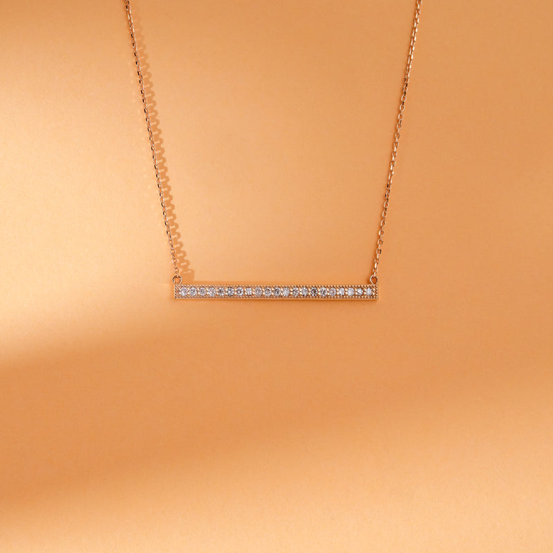 Long vertical bar necklace with pave diamonds in 14k gold