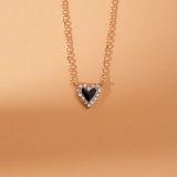 Bold two-tone heart pendant necklace with diamond accent and black enamel.