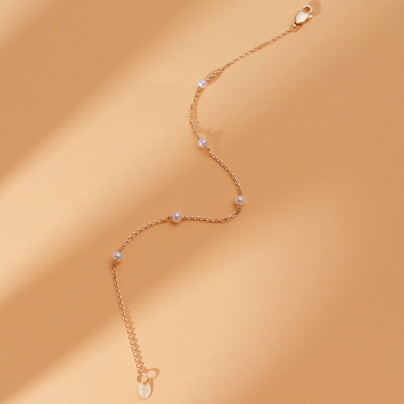 solid gold bracelet with stationed pearls for her