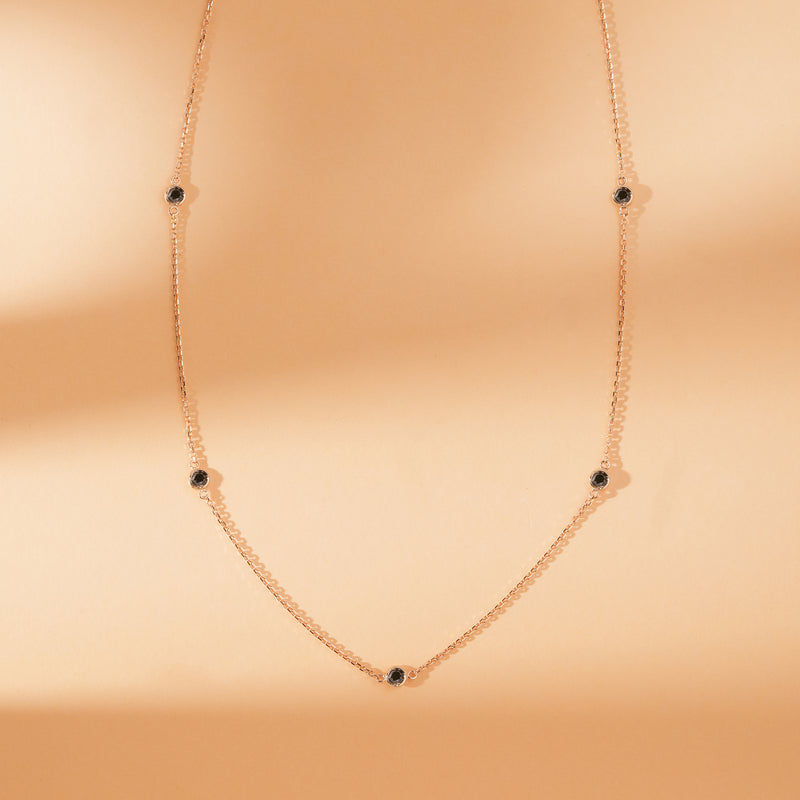 minimalistic solid gold station necklace with natural black diamonds