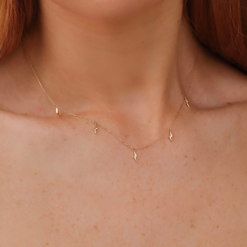 Edgy lightning bolt drop necklace in gold, perfect for a statement piece.