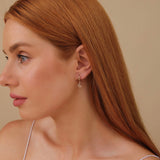 Model wears petite snake charm hoop huggie with natural april birthstone diamonds gift for her