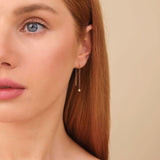 Model wears solid gold handmade fine jewelry threader diamond earring in solid gold 