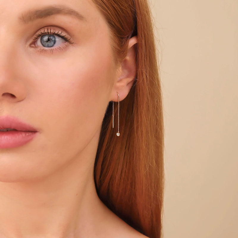 Model wears solid gold handmade fine jewelry threader diamond earring in solid gold 