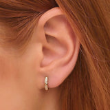 Model wears 14k solid gold pyramid spike round huggie earrings handmade