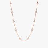 Rose gold diamond station necklace with ten diamond bezels