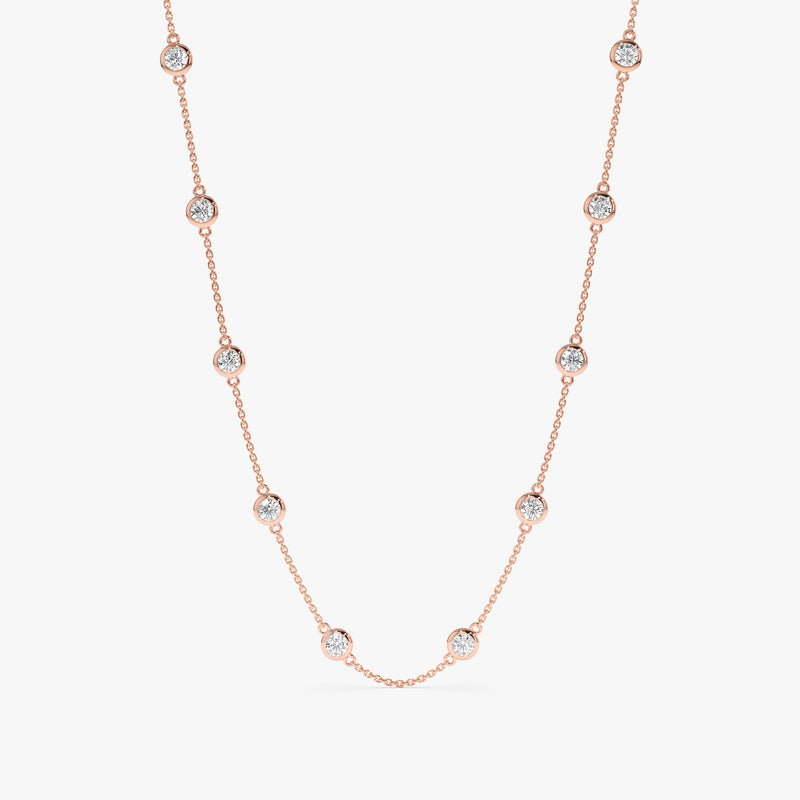 Rose gold diamond station necklace with ten diamond bezels