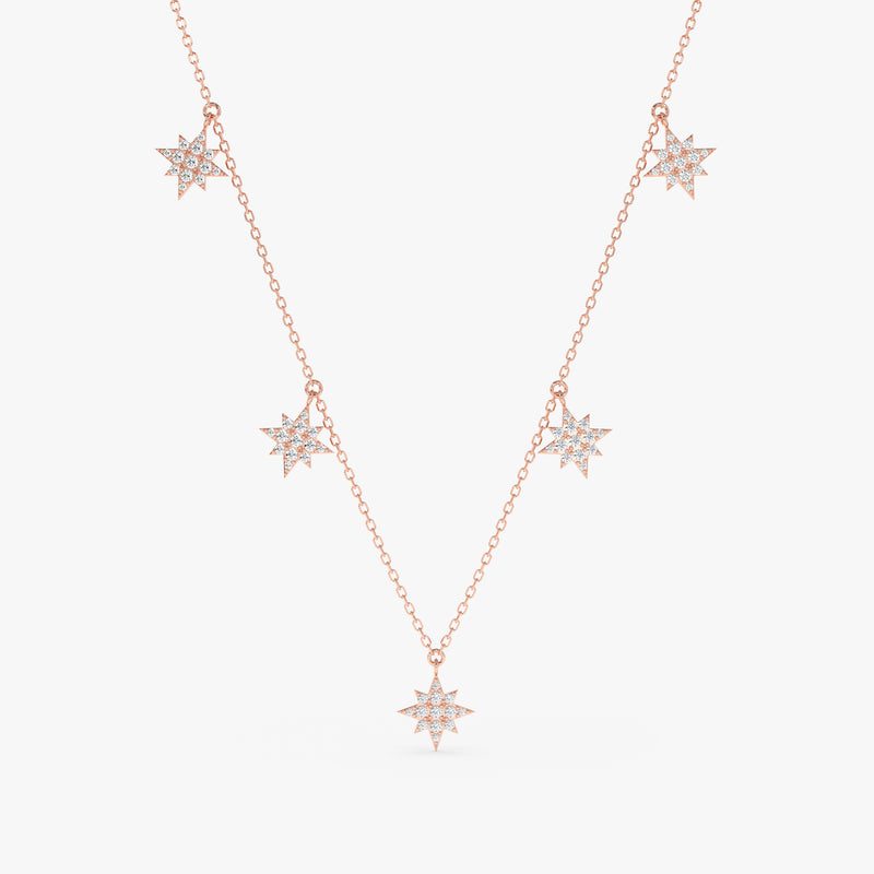 handcrafted solid 14k rose gold necklace with multiple hanging starburst charms with diamonds