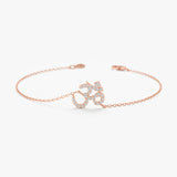 Solid rose gold OM symbol bracelet featuring pave diamonds.