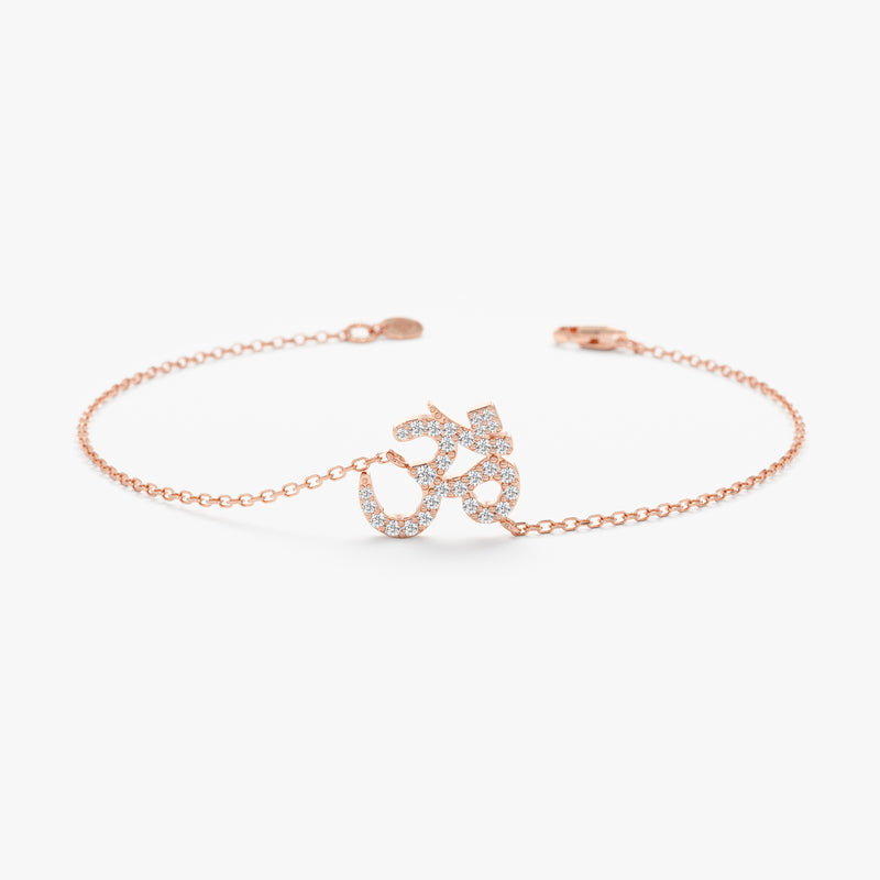 Solid rose gold OM symbol bracelet featuring pave diamonds.