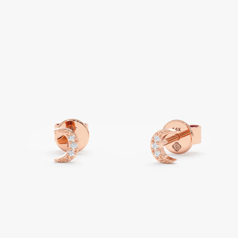 handcrafted pair of solid 14k rose gold stud earrings in crescent moon with diamonds