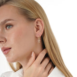 Yume Infuse your style with the geometric precision and elegant symbolism of our Baguette Diamond Cross Huggie Hoops. This striking pair is meticulously crafted in lustrous solid gold, featuring a dazzling cross pendant formed by sleek baguette-cut lab-gr