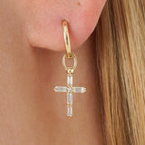 Yume Infuse your style with the geometric precision and elegant symbolism of our Baguette Diamond Cross Huggie Hoops. This striking pair is meticulously crafted in lustrous solid gold, featuring a dazzling cross pendant formed by sleek baguette-cut lab-gr