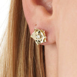 Vexa Infuse your style with the elegant rhythm and timeless beauty of our Gold Floral Diamond Accent Studs. This exquisite pair is meticulously crafted in lustrous solid gold, showcasing a graceful multi-petal flower motif with a highly polished finish. A
