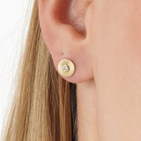 Thia Infuse your style with the radiant energy of our Sunburst Diamond Studs. These exquisite earrings are meticulously crafted from lustrous solid gold, featuring a unique circular motif with deeply engraved sunburst lines radiating outward. At the cente