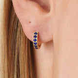 Tovi Infuse your style with the vibrant, celestial energy of our Lapis Lazuli Huggie Hoops. This exquisite pair is crafted in lustrous solid gold, featuring a comfortable small hoop lined with a continuous row of natural lapis lazuli gemstones. The gems a