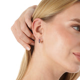 Tovi Infuse your style with the vibrant, celestial energy of our Lapis Lazuli Huggie Hoops. This exquisite pair is crafted in lustrous solid gold, featuring a comfortable small hoop lined with a continuous row of natural lapis lazuli gemstones. The gems a