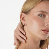 Tovi Infuse your style with the vibrant, celestial energy of our Lapis Lazuli Huggie Hoops. This exquisite pair is crafted in lustrous solid gold, featuring a comfortable small hoop lined with a continuous row of natural lapis lazuli gemstones. The gems a