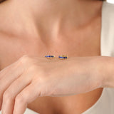 Tovi Infuse your style with the vibrant, celestial energy of our Lapis Lazuli Huggie Hoops. This exquisite pair is crafted in lustrous solid gold, featuring a comfortable small hoop lined with a continuous row of natural lapis lazuli gemstones. The gems a