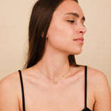 Cutout star necklace with dangling diamond, available in 14k yellow, white, or rose gold