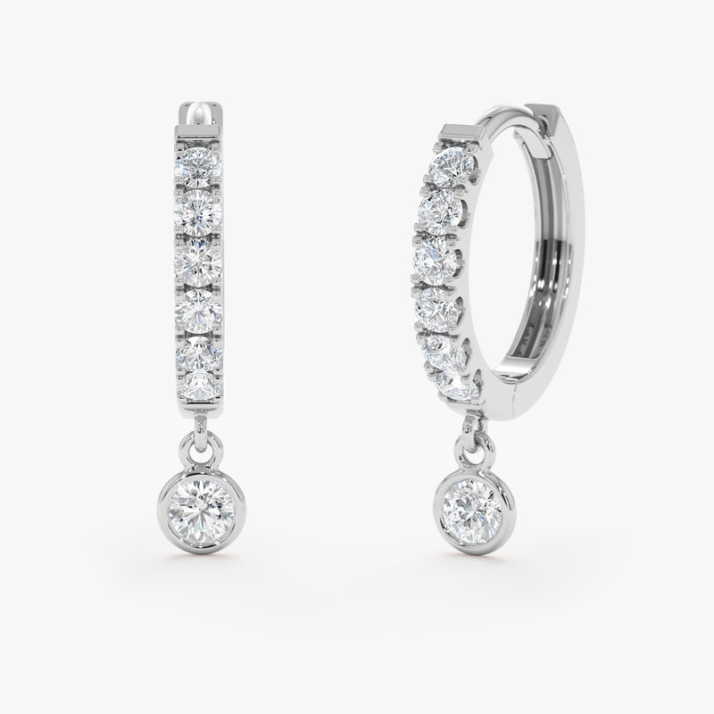 Handcrafted pair of solid 14k white gold diamond lined hoop earrings with hanging diamond bezel
