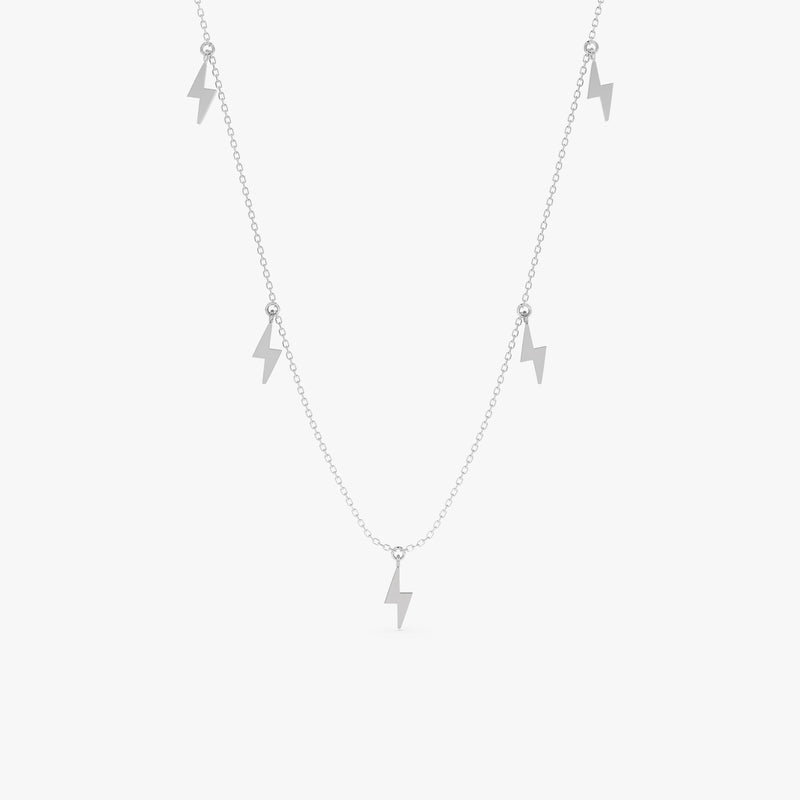 Solid gold necklace featuring five dangling lightning bolt charms.