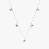 handmade solid white gold necklace with hanging eye charms in white diamonds and blue sapphire