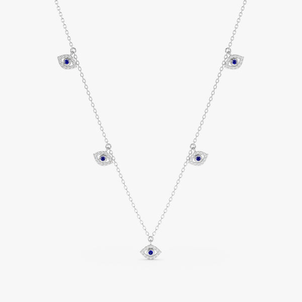 handmade solid white gold necklace with hanging eye charms in white diamonds and blue sapphire