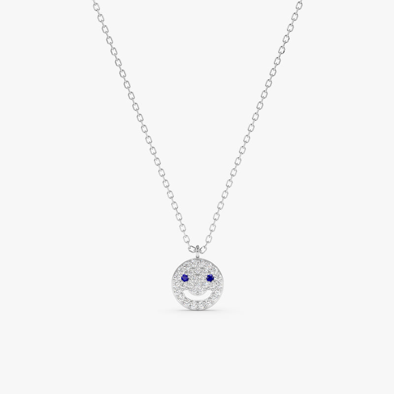 14k solid gold happy face necklace with diamonds and blue sapphires.