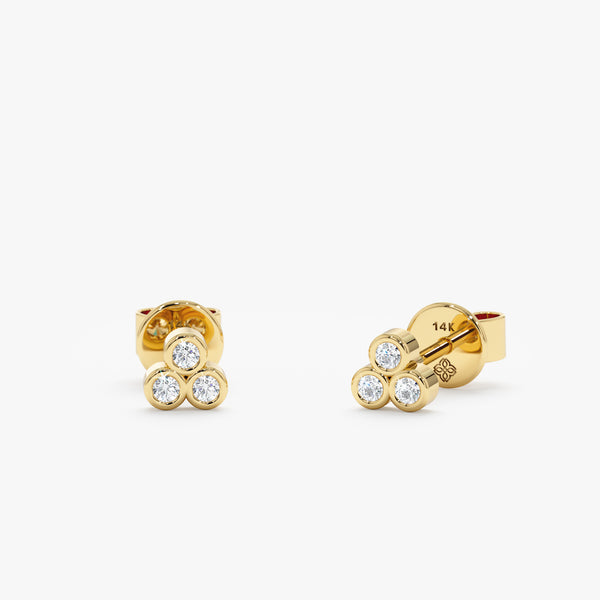 handmade pair of solid gold three bezel diamond stud earrings