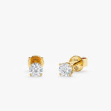 Minimalist Natural diamond earring studs with 4-prong setting in solid gold.