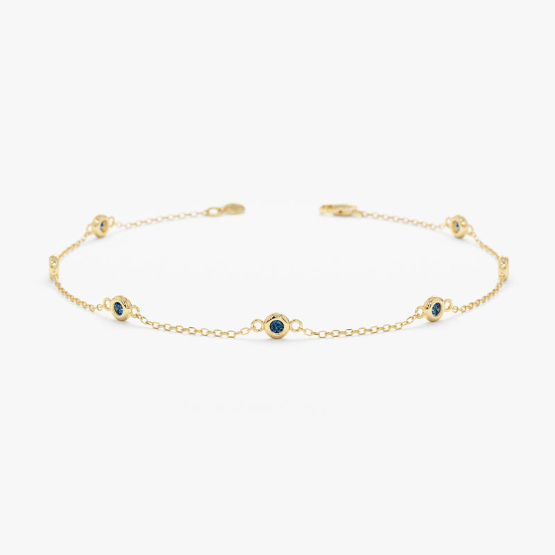 blue topaz bezel station bracelet in solid gold 