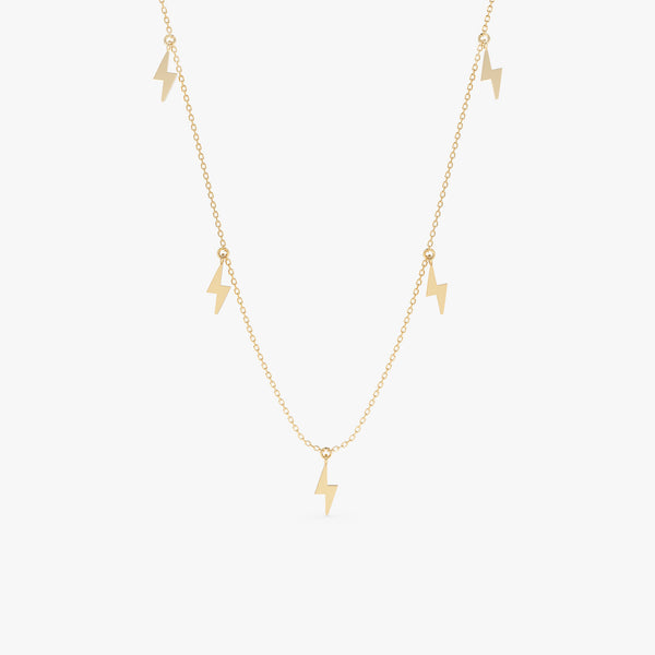 Lightning bolt drop necklace in gold with five polished lightning bolt charms.