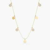 Gold mixed coin drop necklace with alternating smooth gold disks and diamond-studded disks.