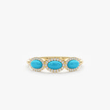 three turquoise gemstones with diamond halo in yellow gold