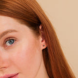 Model wears 14k solid gold black diamond bezel stud earrings 