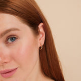 Model wears handmade solid 14k gold earring hoop with stacked diamonds 