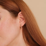 Model wears april birthstone stacked baguette natural diamonds earring hoop