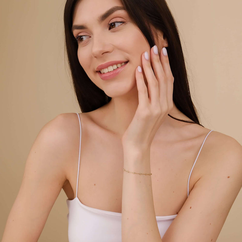 Delicate beaded gold bracelet with a subtle shimmer