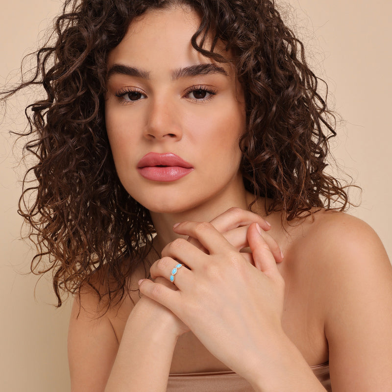 solid gold ring with three oval cut turquoise stones 